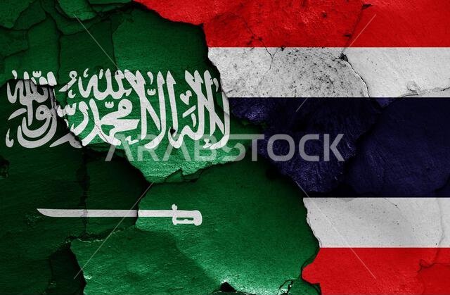 flags of Saudi Arabia and Thailand painted on cracked wall flags of Saudi Arabia and Thailand painted on cracked wall