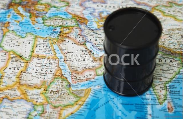 Oil drum with crude petroleum standing on a map Oil drum with crude petroleum standing on a map