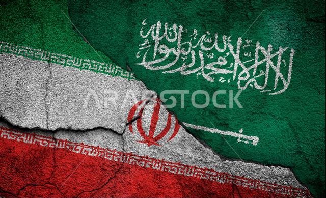 Weathered flags of Iran and Saudi Arabia painted on a cracked wall. Iran–Saudi Arabia proxy conflict or the Middle East Cold War concept.
