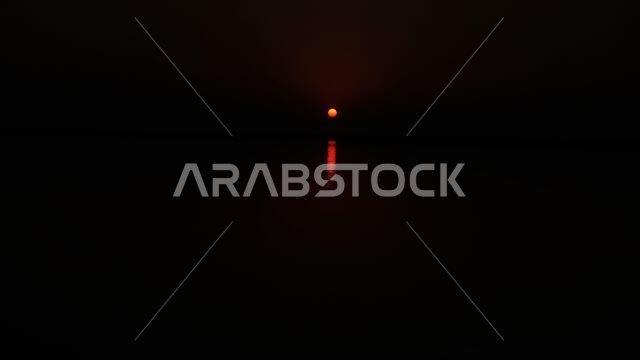 Sun rise at Arabian gulf lighting the dark at Jubail Saudi Arabia
