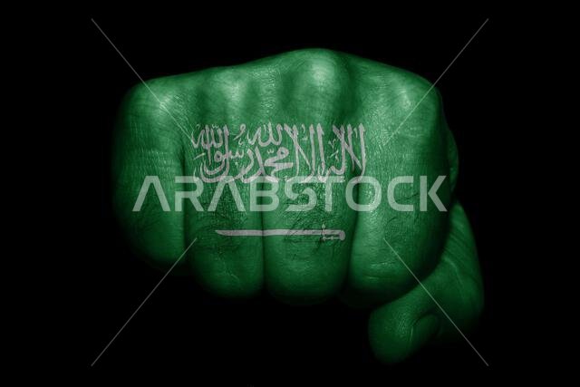 Flag of Saudi Arabia painted on strong fist on black background