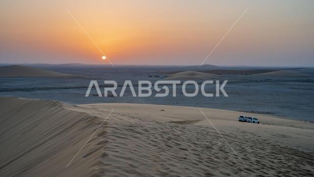 A beautiful evening sunset at singing sand dune in qatar