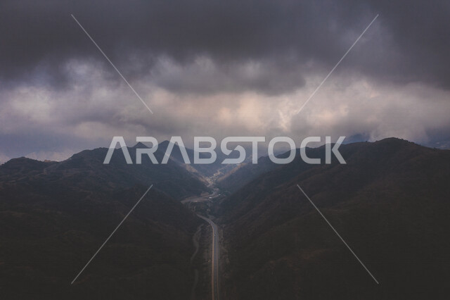 A mountain range in the Arabian Peninsula, mountainous terrain in the Kingdom of Saudi Arabia, paved roads in the middle of the mountains, tunnels in the valleys