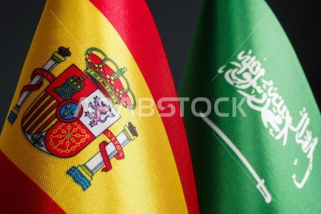 Close-up of the flags of Spain and Saudi Arabia.