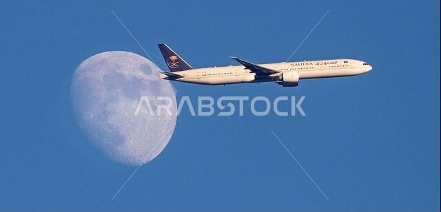 Saudi Arabian Airlines A350-900 plane passes the waxing moon above North London, United Kingdom as it approaches Heathrow Airport
