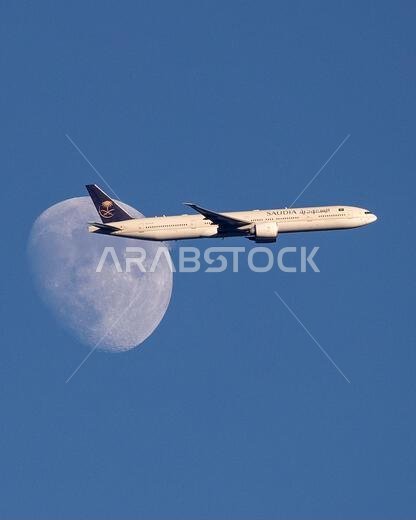 Saudi Arabian Airlines A350-900 plane passes the waxing moon above North London, United Kingdom as it approaches Heathrow Airport