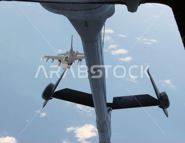 An F-16 Fighting Falcon from the 176th Expeditionary Fighter Squadron, 378 Air Expeditionary Wing at Prince Sultan Air Base, Saudi Arabia, moves in to position to be refueled by a KC-10 Extender, flown by the 908th Air Refueling Squadron, 380th Air Expeditionary Wing, based at Al Dhafra Air Base, United Arab Emirates, Dec. 16, 2021. The KC-10 provides in-air refueling capability to U.S. and allied aircraft throughout the Central Command region. (U.S. Air Force photo by Master Sgt. Dan Heaton)