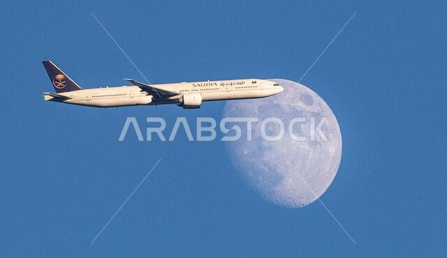 طائرة تابعة للخطوط الجوية السعودية من طراز إيرباص A350-900 تعبر القمر المتزايد فوق شمال لندن، المملكة المتحدة، أثناء اقترابها من مطار هيثرو.