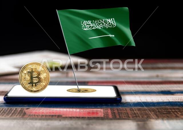 رسم توضيحي لعلم المملكة العربية السعودية مع رمز البيتكوين وجهاز بشاشة فارغة