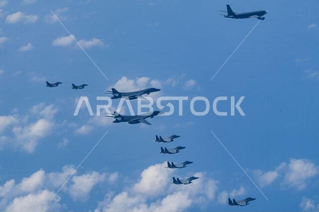 Royal Saudi Air Force F-15’s fly in formation with two U.S. Air Force B-1 Lancers and USAF F-16 Fighting Falcons over the Red Sea, Nov. 11, 2021.  The RSAF fighters accompanied the formation as part of a presence patrol.  (U.S. Air Force photo by Staff Sgt. Jerreht Harris)
