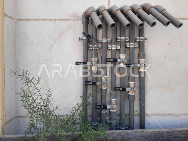 HOFUF AL HASA, SAUDI ARABIA - Oct 17, 2021: The water pipes attached to a wall