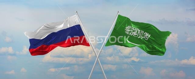 أعلام روسيا والسعودية ترفرف في مهب الريح على أعمدة الأعلام في سماء ملبدة بالغيوم في يوم مشمس. ترمز إلى العلاقة والحوار بين دولتين أعلام روسيا والسعودية ترفرف في مهب الريح على أعمدة الأعلام في سماء ملبدة بالغيوم في يوم مشمس. ترمز إلى العلاقة والحوار بين دولتين