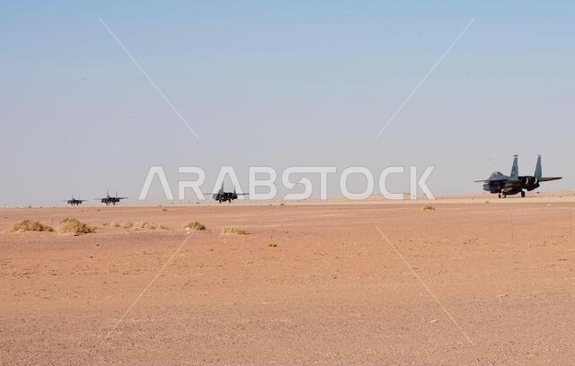 طائرتان من طراز إف-15 إي سترايك إيغل تابعتان لسلاح الجو الأمريكي، من السرب المقاتل الاستكشافي 494، تسيران على مدرج قاعدة الأمير سلطان الجوية في المملكة العربية السعودية، في 4 يناير 2020. تُعدّ طائرة إف-15 إي سترايك إيغل مقاتلة متعددة المهام، مصممة لتنفيذ مهام جو-جو وجو-أرض، مما يُظهر قدرة القيادة المركزية للقوات الجوية الأمريكية على المنافسة والردع والانتصار على الجهات الفاعلة الحكومية وغير الحكومية. (صورة من سلاح الجو الأمريكي، بعدسة الفني الرقيب مايكل تشارلز) طائرتان من طراز إف-15 إي سترايك إيغل تابعتان لسلاح الجو الأمريكي، من السرب المقاتل الاستكشافي 494، تسيران على مدرج قاعدة الأمير سلطان الجوية في المملكة العربية السعودية، في 4 يناير 2020. تُعدّ طائرة إف-15 إي سترايك إيغل مقاتلة متعددة المهام، مصممة لتنفيذ مهام جو-جو وجو-أرض، مما يُظهر قدرة القيادة المركزية للقوات الجوية الأمريكية على المنافسة والردع والانتصار على الجهات الفاعلة الحكومية وغير الحكومية. (صورة من سلاح الجو الأمريكي، بعدسة الفني الرقيب مايكل تشارلز)