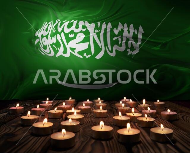 Mourning candles burning on Saudi Arabia national flag of background. Memorial weekend, patriot veterans day, National Day of Service Remembrance. Bur