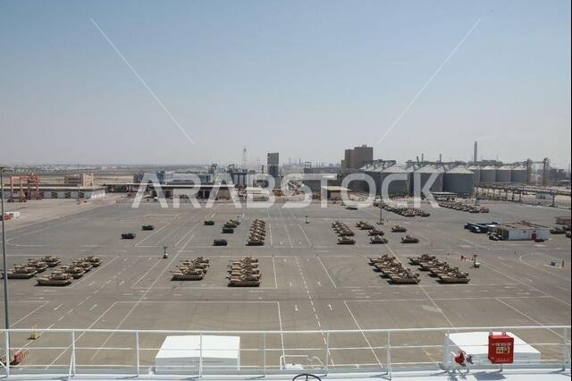 Aerial view from the Liberty Peace as military vehicles are downloaded and staged in preparation for transport to Kuwait at the industrial port at Yanbu, Kingdom of Saudi Arabia, April 20, 2021 as part of the logistics exercise, LOGEX 21. The cargo vessel carried rolling stock to include the M2/A2 Bradley Fighting Vehicle, Light Medium Tactical Vehicles (LMTV), and the High Mobility Multipurpose Wheeled Vehicle (HMMWV). LOGEX 21 demonstrates the 1st TSC’s readiness and ability to provide respons