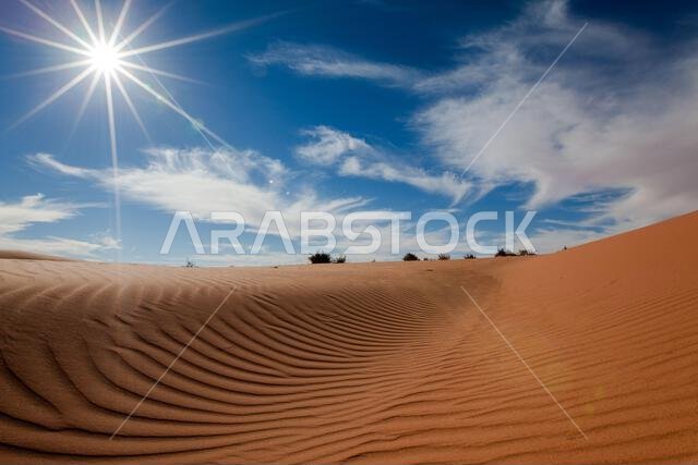 Sunburst over sand dunes in the desert, Saudi Arabia