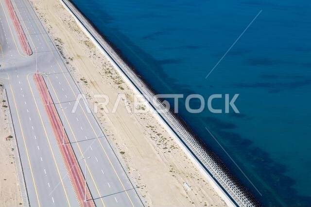 Breakwater with an empty asphalt road on it, aerial view