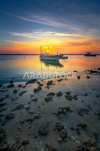 Boats on Dammam sea side with sunrise background view. Dammam, Saudi Arabia.