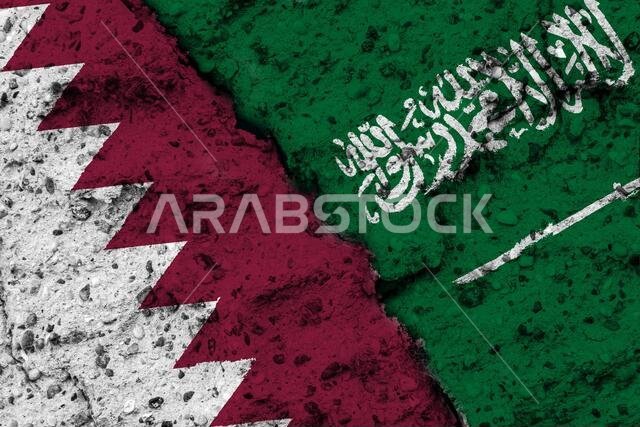Concept of a Relationship between Qatar and Saudi Arabia with painted flags on a rough wall with a crack Concept of a Relationship between Qatar and Saudi Arabia with painted flags on a rough wall with a crack