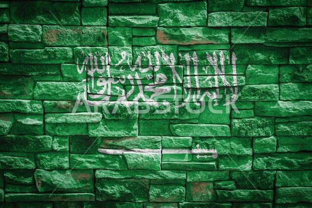National flag of Saudi Arabia   on stone  wall background.The concept of national pride and symbol of the country. Flag  banner on  stone texture back