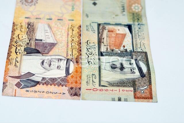 Saudi Arabia ten riyals banknotes with the photo of king Salman bin AbdulAziz and Fortress and the photo of King Abdullah and King Abdulaziz's palace