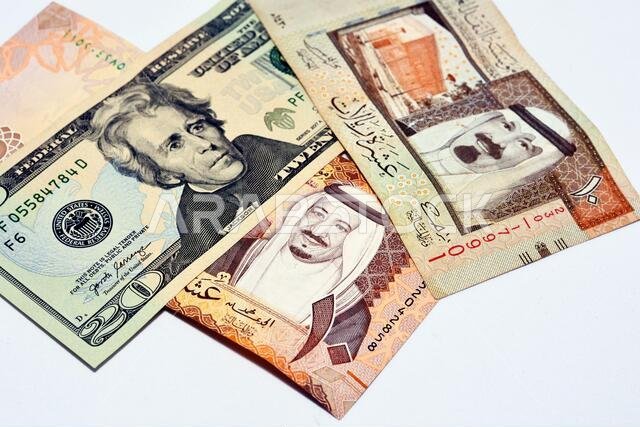 عملة أمريكية من فئة 20 دولارًا، بالإضافة إلى عملات ورقية من فئة 10 ريالات سعودية تحمل صورة الملك سلمان، وعملة أخرى من فئة 10 ريالات سعودية تحمل صورة أحد أقارب الملك سلمان.