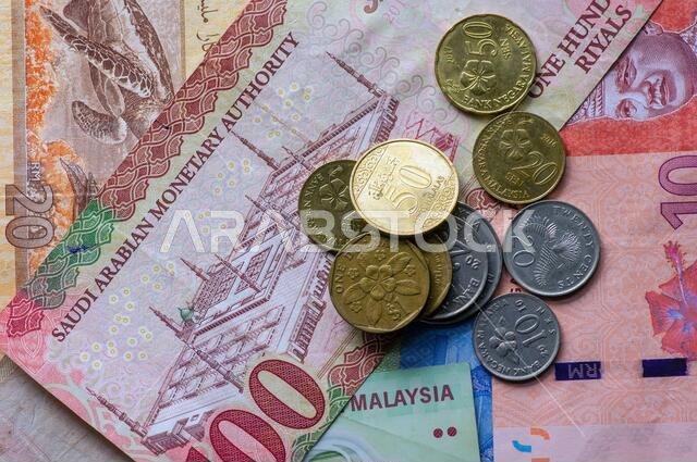 Top view of money, banknote of Ringgit Malaysia, Singapore dollar and Saudi Arabia Riyals for background. Business, Finance, Economy and Investment co Top view of money, banknote of Ringgit Malaysia, Singapore dollar and Saudi Arabia Riyals for background. Business, Finance, Economy and Investment co