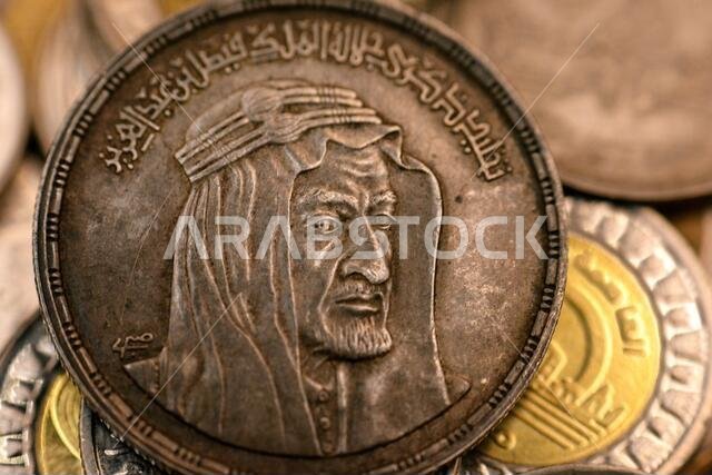 The obverse side of an Egyptian one pound coin, 1 LE coin year 1976, 1396 AH with Bust of King Faisal half right, commemorative to king Faisal Al Saud The obverse side of an Egyptian one pound coin, 1 LE coin year 1976, 1396 AH with Bust of King Faisal half right, commemorative to king Faisal Al Saud