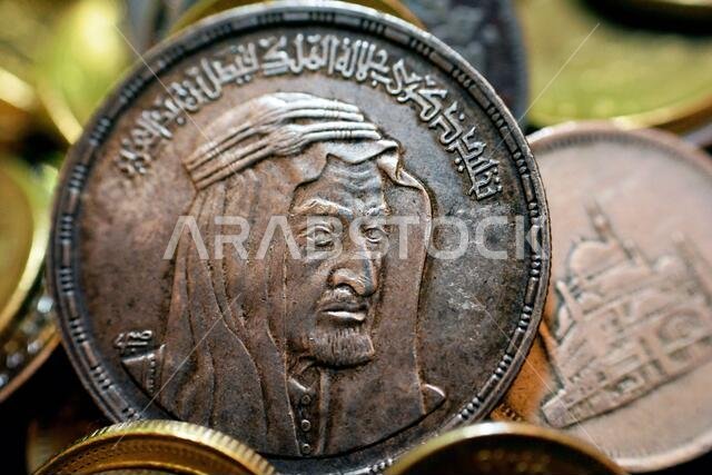 The obverse side of an Egyptian one pound coin, 1 LE coin year 1976, 1396 AH with Bust of King Faisal half right, commemorative to king Faisal Al Saud The obverse side of an Egyptian one pound coin, 1 LE coin year 1976, 1396 AH with Bust of King Faisal half right, commemorative to king Faisal Al Saud
