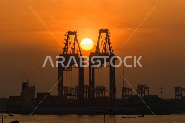 Gantry crane with sunrise sun. Morning at port.