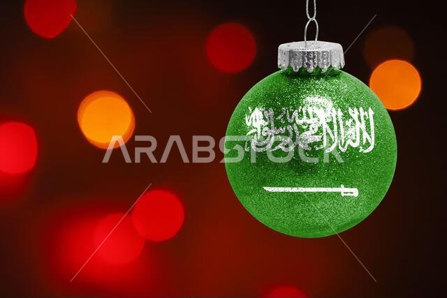 Colorful blurred background and applied the flag of Saudi Arabia on the New Year's toy. New Year 2022 Celebration