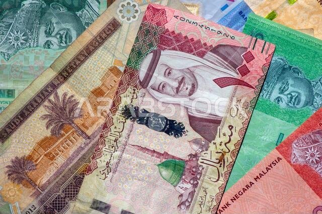Money, Banknote of Ringgit Malaysia and Saudi Arabia Riyals for background. Business, Finance, Economy and Investment concept. Money, Banknote of Ringgit Malaysia and Saudi Arabia Riyals for background. Business, Finance, Economy and Investment concept.