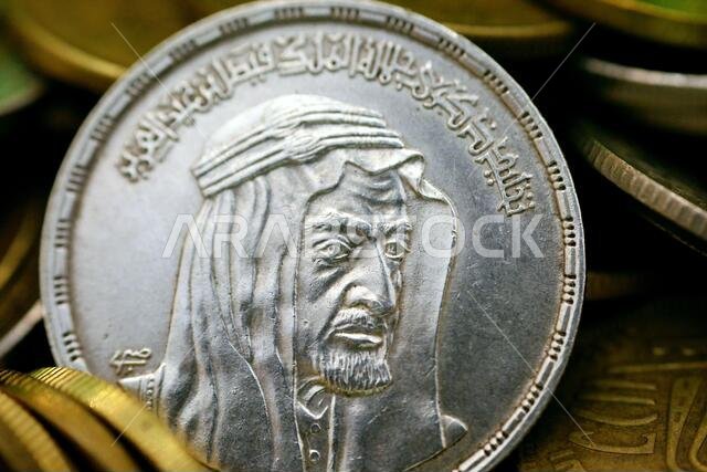 The obverse side of an Egyptian one pound coin, 1 LE coin year 1976, 1396 AH with Bust of King Faisal half right, commemorative to king Faisal Al Saud The obverse side of an Egyptian one pound coin, 1 LE coin year 1976, 1396 AH with Bust of King Faisal half right, commemorative to king Faisal Al Saud