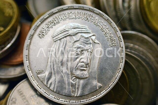 The obverse side of an Egyptian one pound coin, 1 LE coin year 1976, 1396 AH with Bust of King Faisal half right, commemorative to king Faisal Al Saud The obverse side of an Egyptian one pound coin, 1 LE coin year 1976, 1396 AH with Bust of King Faisal half right, commemorative to king Faisal Al Saud
