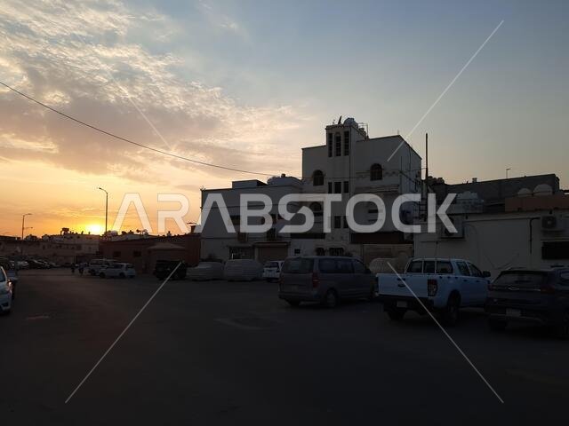 HOFUF AL HASA, SAUDI ARABIA - Jul 07, 2021: The city buildings cars on the street during sunset