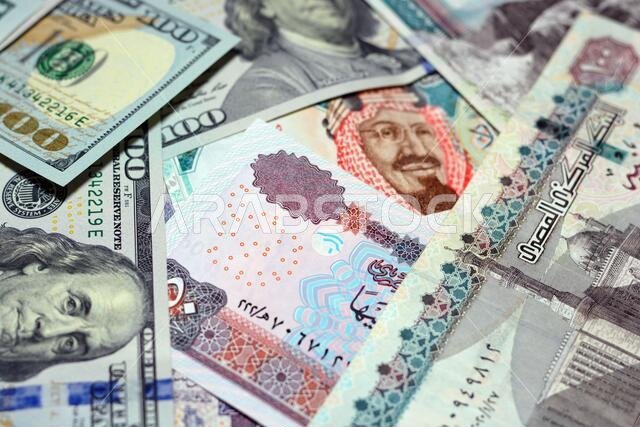 Saudi Arabia currency with USA currency and Egypt currency. blurred money . Saudi Arabia riyals, Egyptian pounds and American dollars exchange rate