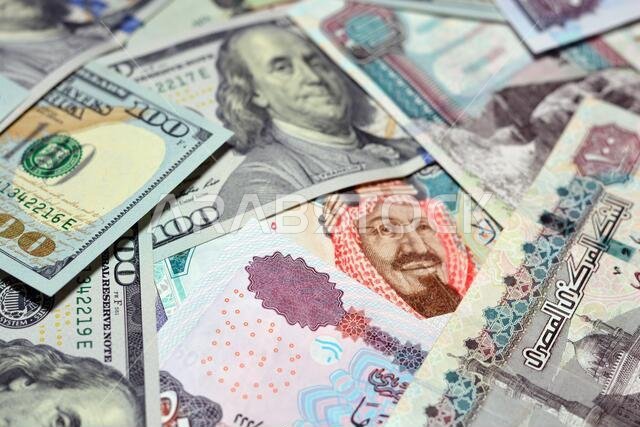 Saudi Arabia currency with USA currency and Egypt currency. blurred money . Saudi Arabia riyals, Egyptian pounds and American dollars exchange rate