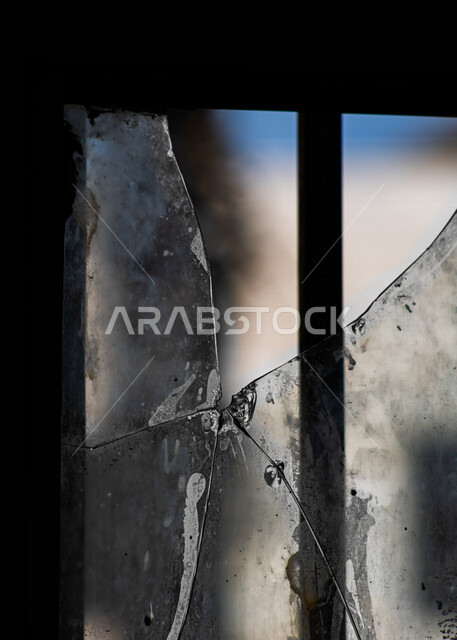Close-up of broken glass, window glass, broken window, window frame, black background