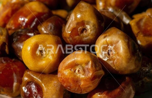 Close up of sweet sukkari dates fruit  (Kurma Sukkari) from Saudi Arabia ready for ramadan