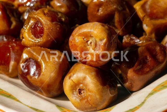 Close up of sweet sukkari dates fruit  (Kurma Sukkari) from Saudi Arabia ready for ramadan