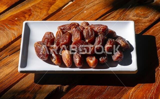 Sweet  Khalas dates fruit from Saudi Arabia in the white plate ready for ramadan