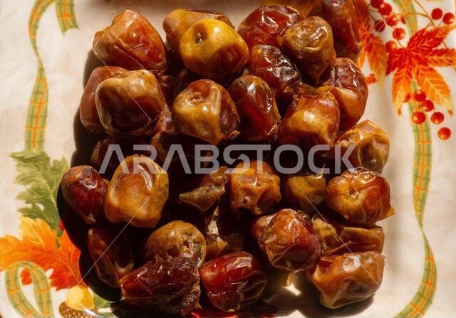 Top view of sweet sukkari dates fruit  (Kurma Sukkari)  on a plate from Saudi Arabia ready for ramadan