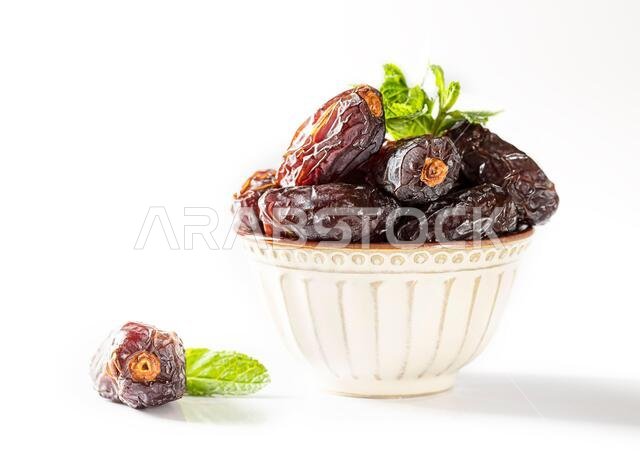 Dates fruit and rosary still life against on white background. Ramadan background greeting card. Ramadan Kareem. Traditional culture of the Middle Eas