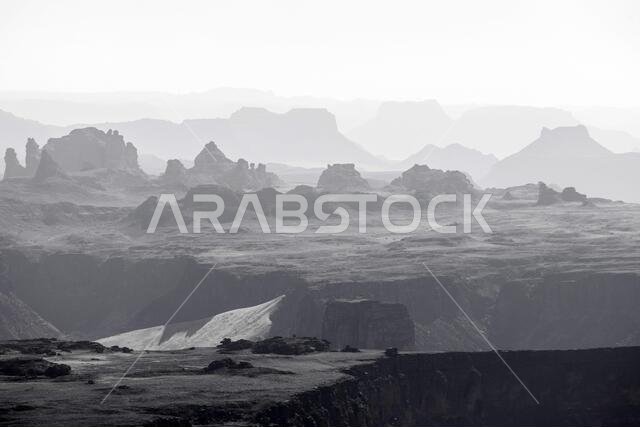 Eroded mountains in the haze of the desert of Al Ula, Saudi Arabia