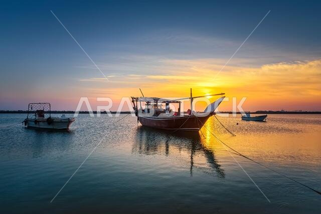 Boats on Dammam sea side with sunrise background view. Dammam, Saudi Arabia.