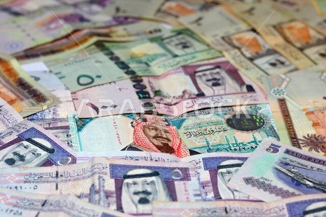 collection of Saudi Arabia money background, different Saudi riyals collection of 100, 50, 20, 10, 5 and 1 riyal, selective focus of Saudi money.