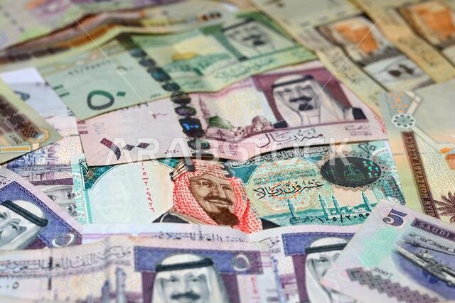collection of Saudi Arabia money background, different Saudi riyals collection of 100, 50, 20, 10, 5 and 1 riyal, selective focus of Saudi money.