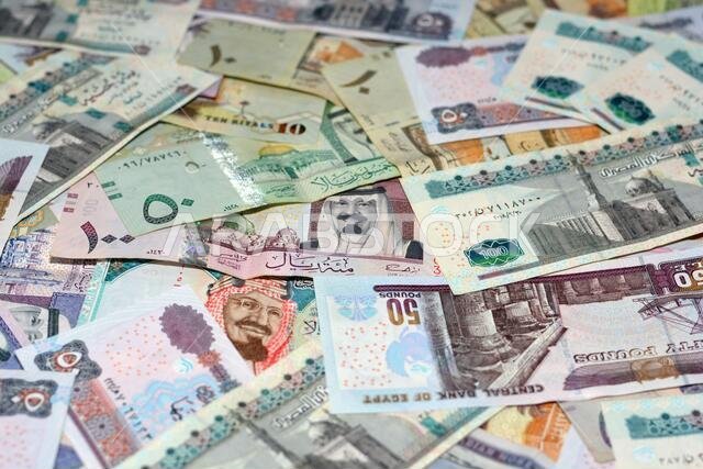 Saudi Arabia riyals and Egyptian pounds background, selective focus of Saudi and Egyptian money