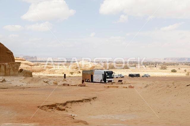 Al Ula, Saudi Arabia, February 19 2020: Parking lot for the rock formation to the Siq Jabal Ithlib in Al Ula, Saudi Arabia. Tour Bus ist waiting for t