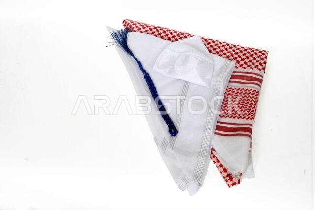 Arabic cultural traditional clothing accessories,Shemagh,White Ghutrah,islamic cap and rosary isolated on white background Arabic cultural traditional clothing accessories,Shemagh,White Ghutrah,islamic cap and rosary isolated on white background